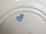 a white plate with a blue design on it