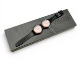 a couple of watches sitting on a black box