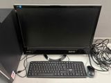 a computer monitor and keyboard sitting on a desk