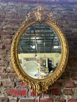a mirror hanging on a brick wall near a brick wall