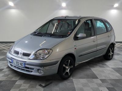 a silver car that is parked on a checkered floor