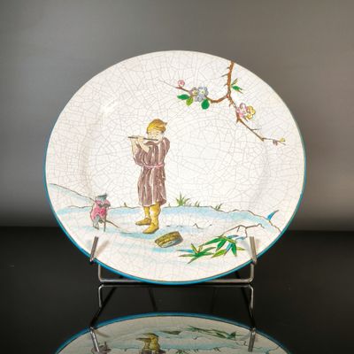 a plate with a picture of a man and a bird on it