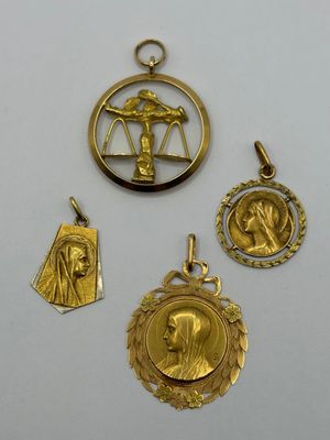 a group of four gold pendants including a lady, a lady, and a lady