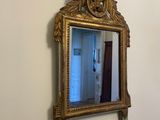a mirror hanging on the wall above a sink