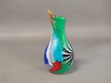 a glass vase that has a colorful design on it