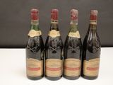 quatre bouteilles de vin sont alignées sur une table