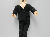 a doll of a man with a mustache on a gray background