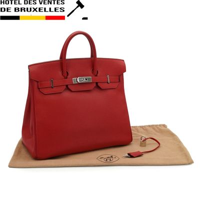 a red leather handbag sitting on top of a brown bag