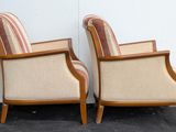 pair of vintage upholstered armchairs with striped upholstered cushions