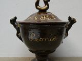 a brown bowl with writing on it sitting on a table