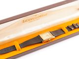 an image of a longines watch in a box on a white surface