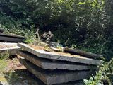 a stone bench in the middle of a grassy area