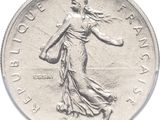 an image of a silver coin with a woman holding a basket
