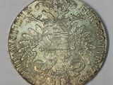a close up of a silver coin with a crown on it