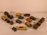 a lot of toy army vehicles on a white surface