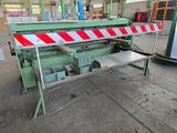 an image of a machine that is working on a piece of metal