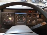 a steering wheel and dashboard of a car with a clock