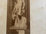 an old photo of a statue of a man on a pedestal
