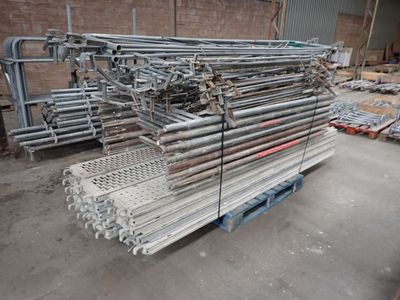 a large pile of steel pipes in a warehouse
