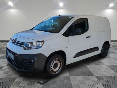the white van is parked on a checkered floor in a room