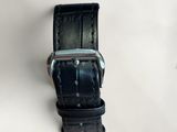 a black leather strap with a silver buckle on it