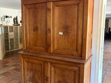 a large wooden cabinet in the middle of a room