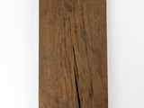 a close up of a piece of wood on a white surface