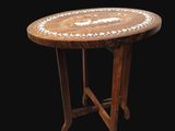 an image of a small wooden table with a white and brown design on it