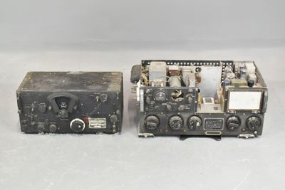two old radio equipment sitting on top of a white surface