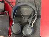 headphones and a charger sitting on a red table