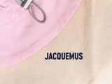 a pink hat with a zipper on top of it