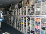 many shelves of yarn and other items in this room