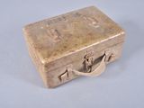 a small metal box with a handle on a table