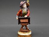a figurine of a man playing a musical instrument