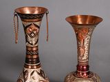 two vases sitting next to each other on a table