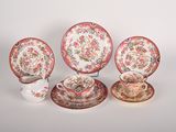 four pieces of porcelain dishes and cups with floral designs on them
