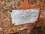 a rusted piece of metal with a sign on it