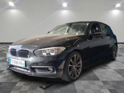 a picture of a black bmw car in a showroom