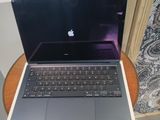 an apple laptop computer sitting on top of a wooden table