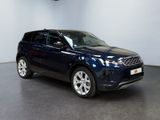 a blue land rover parked in a showroom