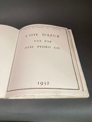 un livre ouvert posé sur une table à côté d'une tasse de café