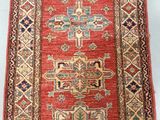 a red and blue rug with a pattern on it
