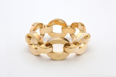 a close up of a gold ring on a white surface