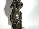 bronze statue of a woman holding a baby in her arms