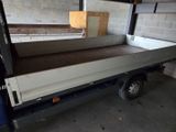 a truck with a flat bed in a garage