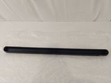 a close up of a black pen sitting on top of a white sheet