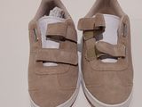 beige shoes with white soles on a white surface