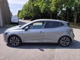 the silver car is parked on the side of the road