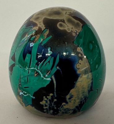 a green and black ball with a picture of a hand on it
