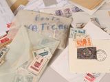 a pile of old letters and stamps on a table
